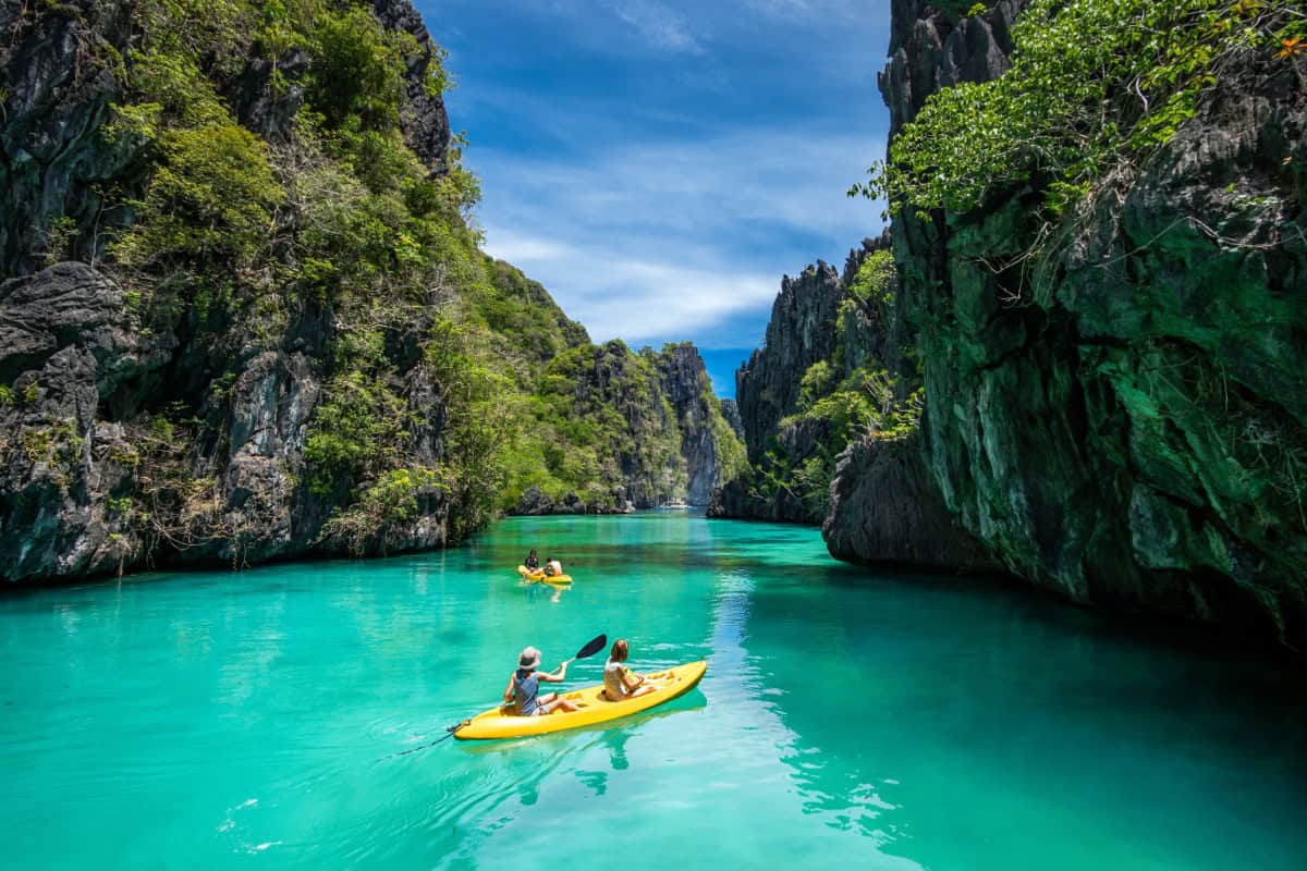 Big Lagoon kayak tour, El Nido Kayakers paddling the turquoise water of Big Lagoon, El Nido