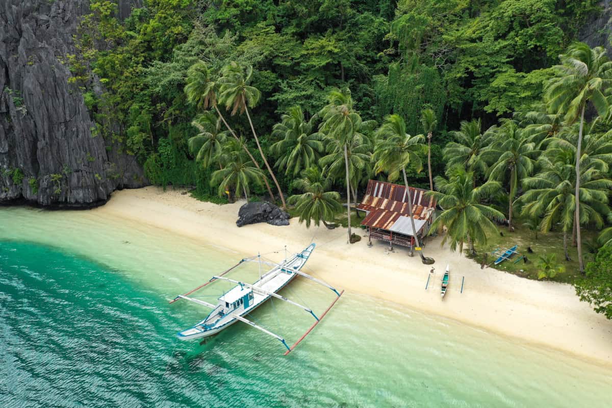 Bangka boat on a Palawan beach Traditional bangka outrigger on a secluded Palawan beach