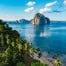 El Nido bay with karst island and palm-fringed coast at golden hour